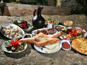 TOP 3 Georgian wines for dinner? The best Georgian wines for dinner? If you're a wine lover and like to try new flavours, you'll have heard of Georgian wines. Georgia is a country with a rich wine tradition and offers some of the best wines in the world. But what Georgian wines to choose for dinner? Here we have a list of three recommended Georgian wines to help you perfect your dining experience. 1. Saperavi - dry wine for dinner Saperavi is one of the most famous Georgian wines and is a great choice for heavier meat dishes. This wine is known for its dark colour and full flavour. Saperavi is made from the grape of the same name, which is considered one of the best for wine. Its notes of blackcurrant and sharp cherry make every bite an unforgettable experience. Georgian Saperavi wine is exceptional and full of flavour, making it a great match for a variety of dishes. Here are some recommendations on what to drink Georgian Saperavi wine with: Beef: Saperavi is an excellent companion for beef. Its full and spicy flavour perfectly complements the richness and texture of beef. Try grilled steak or braised beef with this wine. For grilled steak, choose Saperavi. Its rich and full flavor will complement the taste experience of the meat perfectly. Traditional Georgian food: Of course, Saperavi is the perfect accompaniment to traditional Georgian dishes such as khachapuri (cheese bread), khinkali (stuffed dumplings) or nut sauce. Its distinctive flavour enhances the authenticity of these dishes. Cheese: If you like cheese, Saperavi is a great choice to go with it. You can indulge in a slice of cheese such as brie, camembert or cheddar, and Saperavi wine will give it a twist. Dark chocolate: For sweet consumption, Saperavi is a great companion to dark chocolate with a high cocoa content. Dark chocolate and Saperavi create a delicious combination of bitter and fruity flavours. Mediterranean cuisine: Saperavi wine goes well with Mediterranean dishes such as risotto, seafood and grilled vegetables. Its richness and texture blend well with these flavours. Remember that wine selection is partly a matter of personal taste, so don't hesitate to experiment and discover new food and wine combinations that you like best. Saperavi is a great Georgian wine to enjoy in the company of good food and friends. 2. Rkatsiteli - dry wine for fish dishes at dinner Rkatsiteli is a Georgian white wine that goes well with lighter dishes such as fish, poultry or salads. This wine has a fresh and fruity taste that will complement your dishes beautifully. Its subtle notes of green apple and citrus will add a zesty touch to your meal. Rkatsiteli Georgian wine has a fresh and fruity taste that will go well with a variety of dishes. Here are some recommended food combinations with Rkatsiteli Georgian wine: Fish and seafood: Rkatsiteli is an excellent companion for fish and seafood. You can enjoy baked salmon, steamed shrimp or calamari. Its fresh notes of green apple and citrus will go well with the flavours of seafood. Rkatsiteli goes well with lighter fish dishes such as baked salmon or fish fillet. Its fresh notes of green apple and citrus bring out the flavour of the fish. Salads: Rkatsiteli is an ideal wine for a variety of salads, especially those with a light and refreshing dressing. Try, for example, a Greek salad with feta or a Caesar salad. Poultry: This wine is also great with poultry such as chicken or duck. Its fresh and fruity taste can accentuate the tenderness of poultry meat. Cheeses: you can pair Rkatsiteli with light cheeses such as brie, mozzarella or feta. Its fresh and fruity flavour can mellow out cheese flavours. Asian cuisine: If you like Asian cuisine, Rkatsiteli is a great match for dishes with exotic flavours. Try it with sushi, Thai curries or lemongrass dishes. Fried chicken wings: this wine can be a great accompaniment to fried chicken wings. Its fresh and fruity flavor helps reduce the spiciness of fried foods. 3. Kindzmarauli - dessert wine for dinner If you like sweeter wines, then you should try Kindzmarauli. This semi-sweet red wine is ideal for desserts or as an aperitif. Its rich taste of cherries and blackberries will make every bite a festive moment. Semi-sweet and with a rich taste of cherries and blackberries, Kindzmarauli Georgian wine is ideal for complementing certain specific dishes and desserts. Here are some recommended food combinations with Kindzmarauli Georgian wine: Chocolate dessert: Kindzmarauli excels when paired with chocolate desserts. The combination of sweet wine with dark chocolate creates a delicious contrast of flavours. Try it with chocolate cake or fondant. Tiramisu: This sweet Georgian wine also goes well with the Italian dessert tiramisu. Its cherry notes and sweetness add even more character to this dessert. Fruit desserts: the Kindzmarauli can be combined with various fruit desserts such as cherry pies, blueberry muffins or strawberry pancakes. Its fruity taste will complement these dishes perfectly. Hard cheeses: If you like cheese, you can pair Kindzmarauli with hard cheeses such as Parmesan or pecorino. The sweetness of the wine will contrast with the spiciness of the cheese. Nutty desserts: this wine is also a great match for nutty desserts such as walnuts in honey or hazelnuts in caramel. Soups with fruit: Kindzmarauli can also be an interesting element in fruit soups such as red fruit soup. Its sweetness and cherry aroma add a rich flavour to the soup. These Georgian wines are just a few examples of Georgia's rich wine heritage. Whether you like red, white or sweet wine, you're sure to find something to your liking. Treat yourself to a great dining experience and sample some of Georgia's finest wines with dinner. Your taste buds will thank you! Georgian wines for dinner