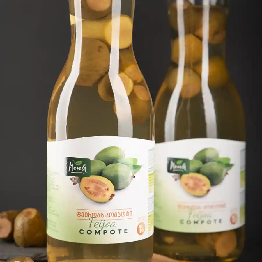 Nena Compote Feijoa - 1 L Feijoa is a fruit you won't find in Czech supermarkets — but once you taste it, you'll understand why Georgians love it. A compote with delicate aromas of pineapple, wild strawberry and mint. A jar of Georgian autumn on your table. Nena Compote Feijoa - 1 L - Image 2